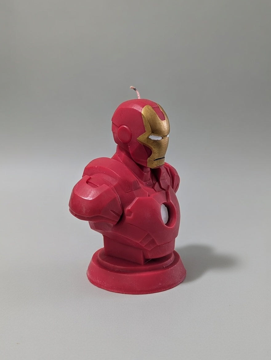 Red robot-shaped candle on a gray background