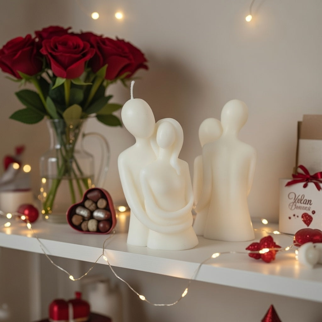 Decorative candles shaped like people on a shelf with flowers and lights in the background