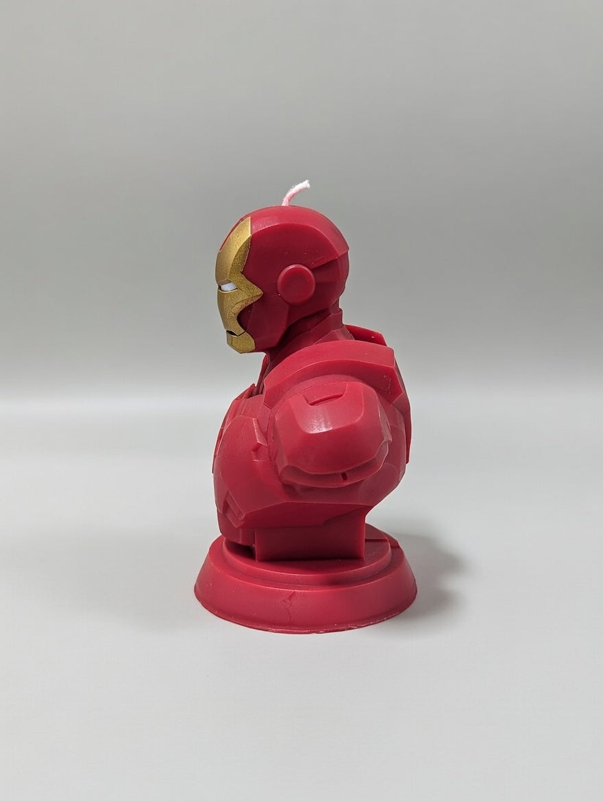Red superhero figurine candle on a gray background