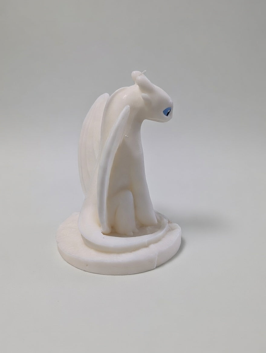 Light Fury Candle facing backwards on a light grey background