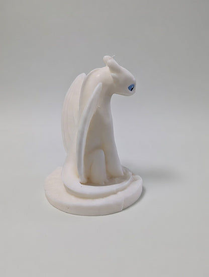 Light Fury Candle facing backwards on a light grey background