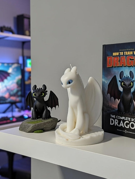 Shelf with 'How to Train Your Dragon' book and a Light Fury Dragon Candle figurine in a gaming room setting. 