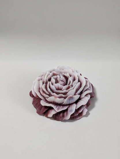 Maroon Peony flower candle with white tips on a light gray background