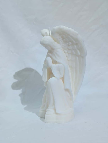 White angel figurine on a light gray background