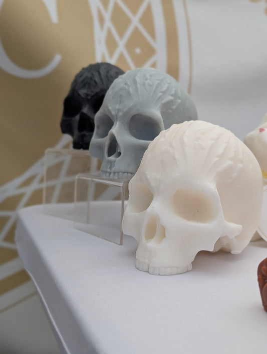 Skull-shaped objects on a white surface with a blurred background