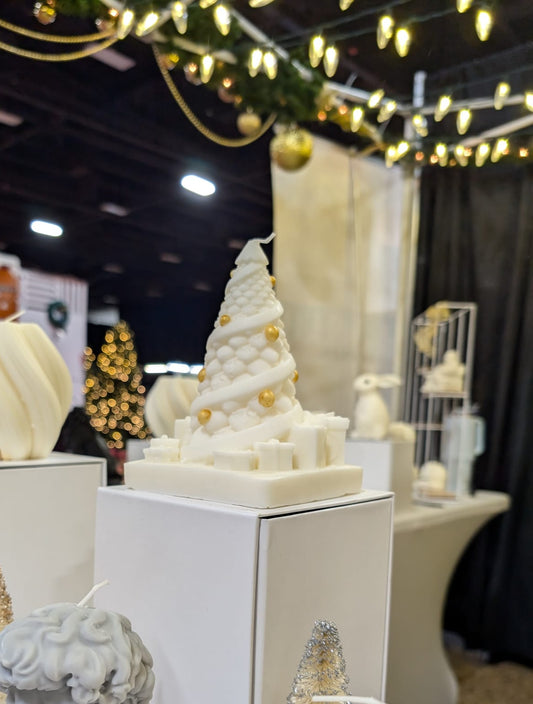 Decorative Christmas Tree display with white sculptures in a festive indoor setting.