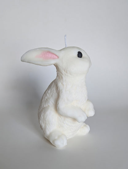 White rabbit-shaped candle on a light gray background