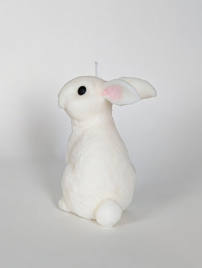 White rabbit-shaped candle on a light gray background