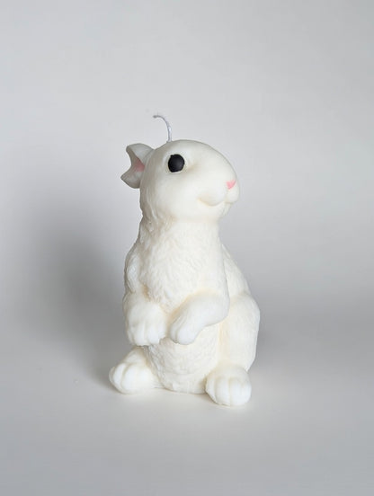 White rabbit-shaped candle on a light gray background
