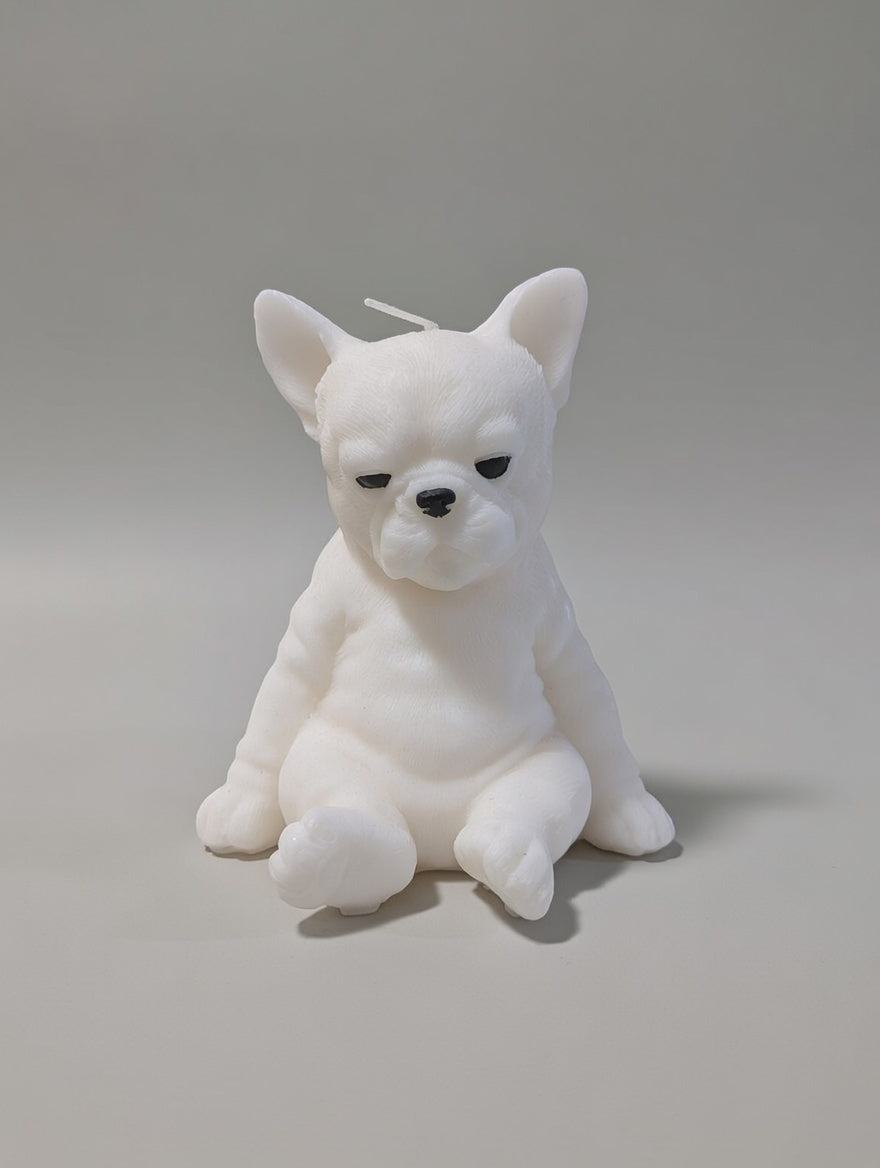 White Fernch Bulldog-shaped candle on a gray background