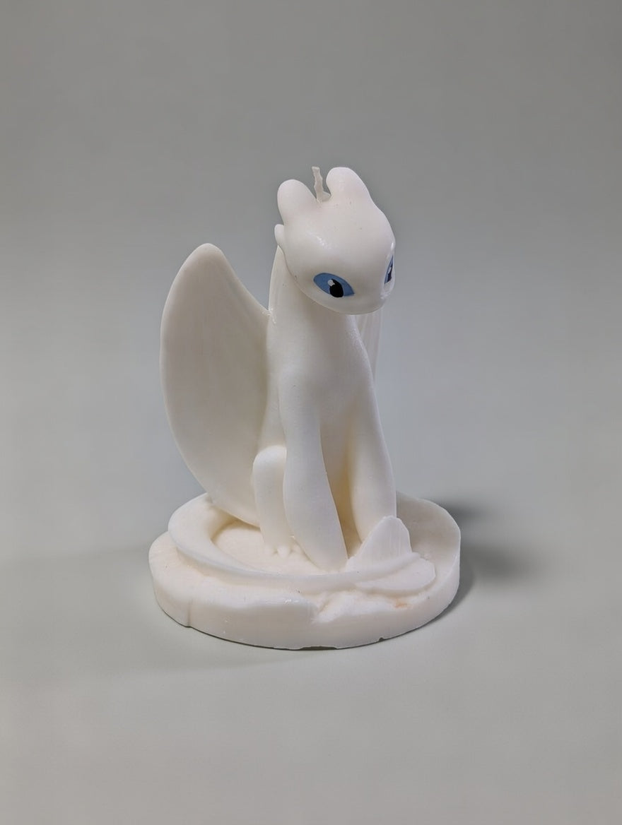 White Light Fury dragon figurine candle on a gray background