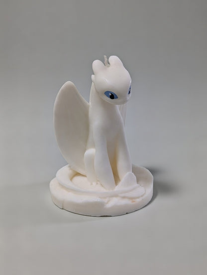 White Light Fury dragon figurine candle on a gray background
